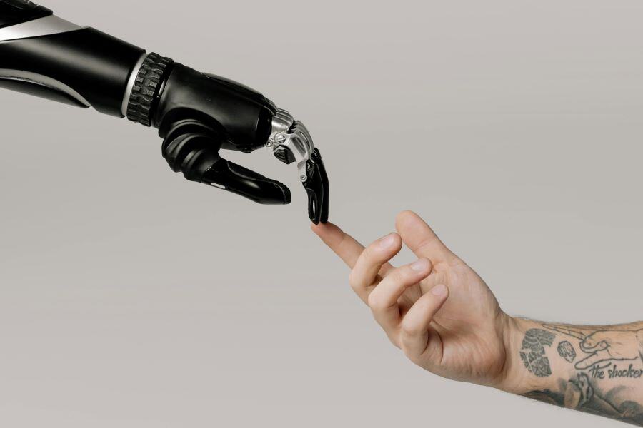 Man and robot touching fingers