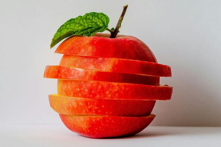 Apple sliced and stacked vertically