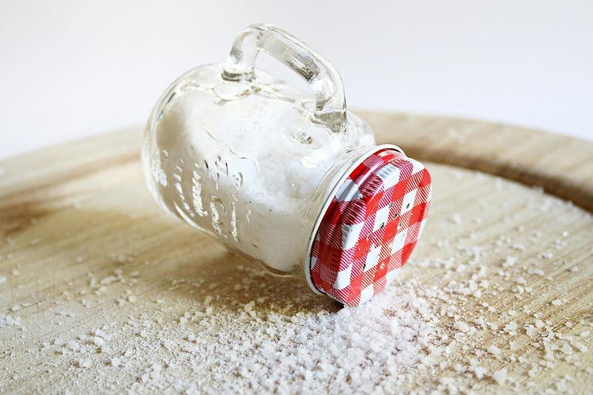 Salt container tipped on its side and spilling