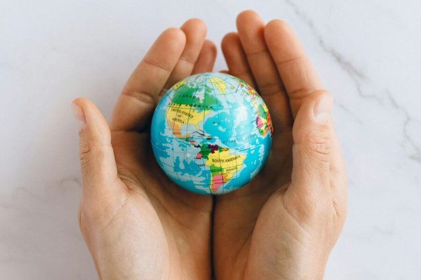 Image of a globe in the palm of hands
