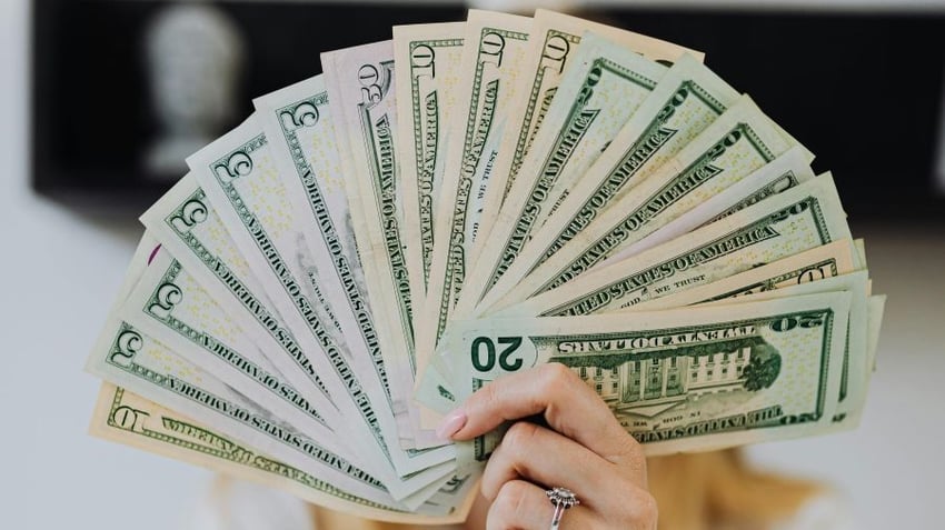 Woman holding U.S. currency